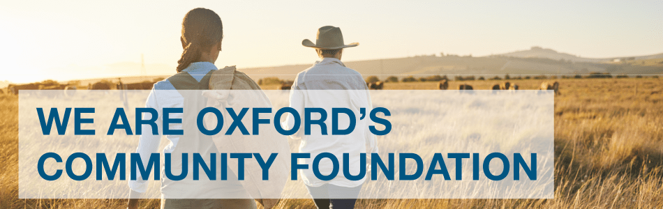 We are Oxford's Community Foundation words over an image of two women walking in a field.